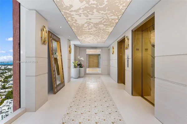 a view of hallway with furniture and a shower