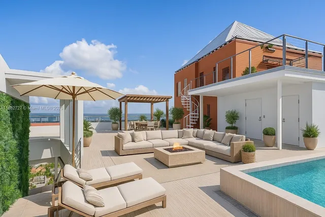 a view of a patio with couches table and chairs with potted plants
