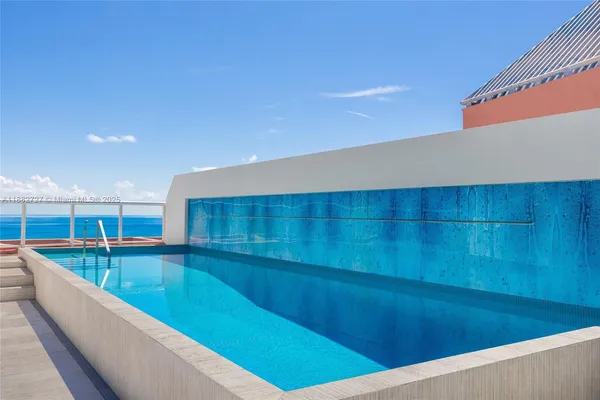 a swimming pool with a outdoor seating