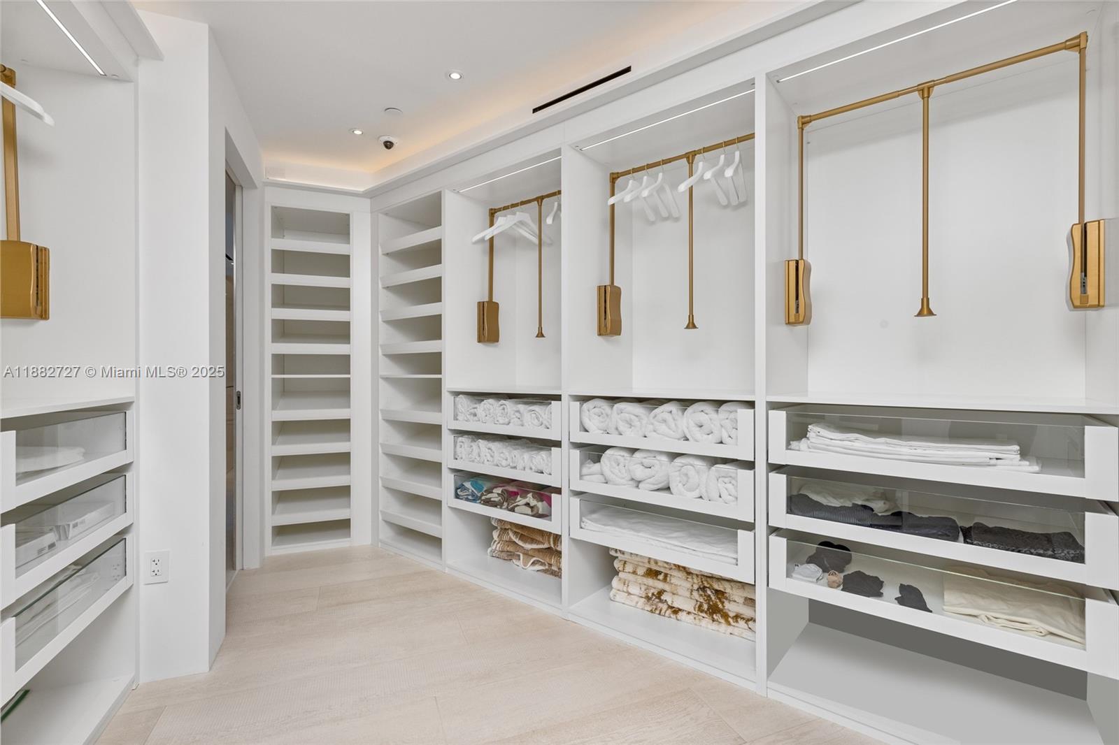 300 South Pointe Drive, Unit PH5 Miami Beach, FL 33139 - Photo 41 of 52 a view of walk in closet with empty racks