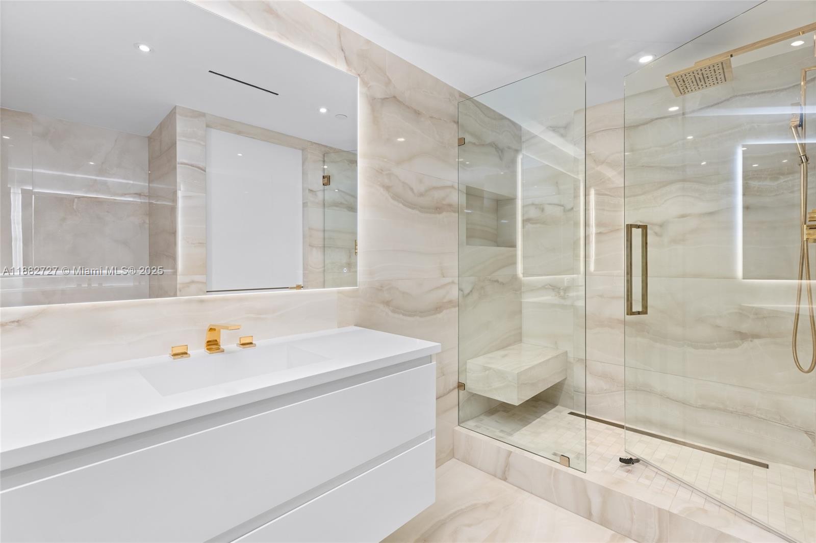 300 South Pointe Drive, Unit PH5 Miami Beach, FL 33139 - Photo 44 of 52 a bathroom with a shower sink and mirror