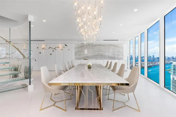a view of a dining room with furniture wooden floor and chandelier