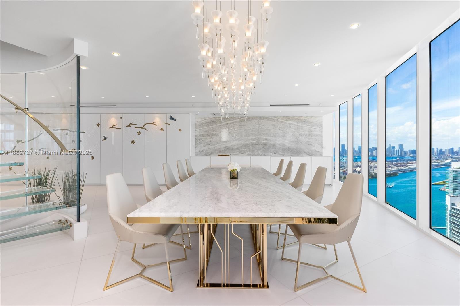 300 South Pointe Drive, Unit PH5 Miami Beach, FL 33139 - Photo 10 of 52 a view of a dining room with furniture wooden floor and chandelier