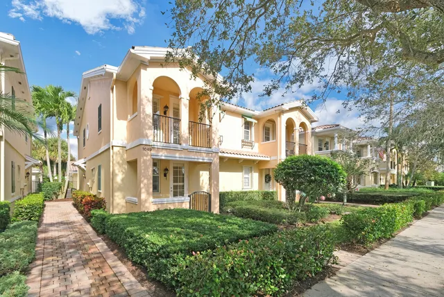 a front view of a house with a garden