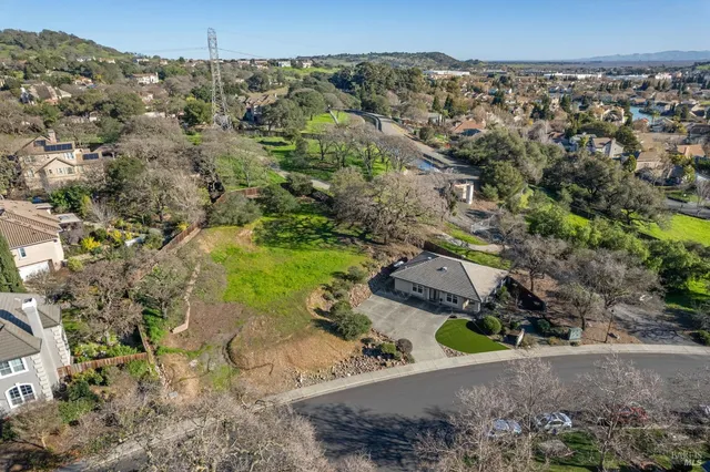 an aerial view of a house with a yard