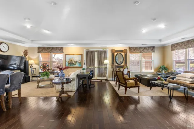 a living room with fireplace furniture and a wooden floor