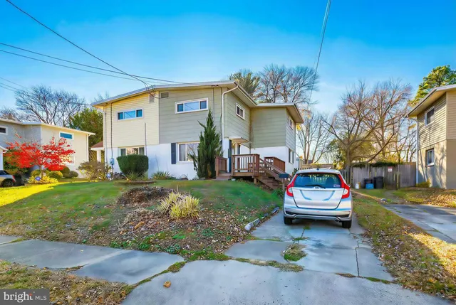 a view of house with outdoor space and garden