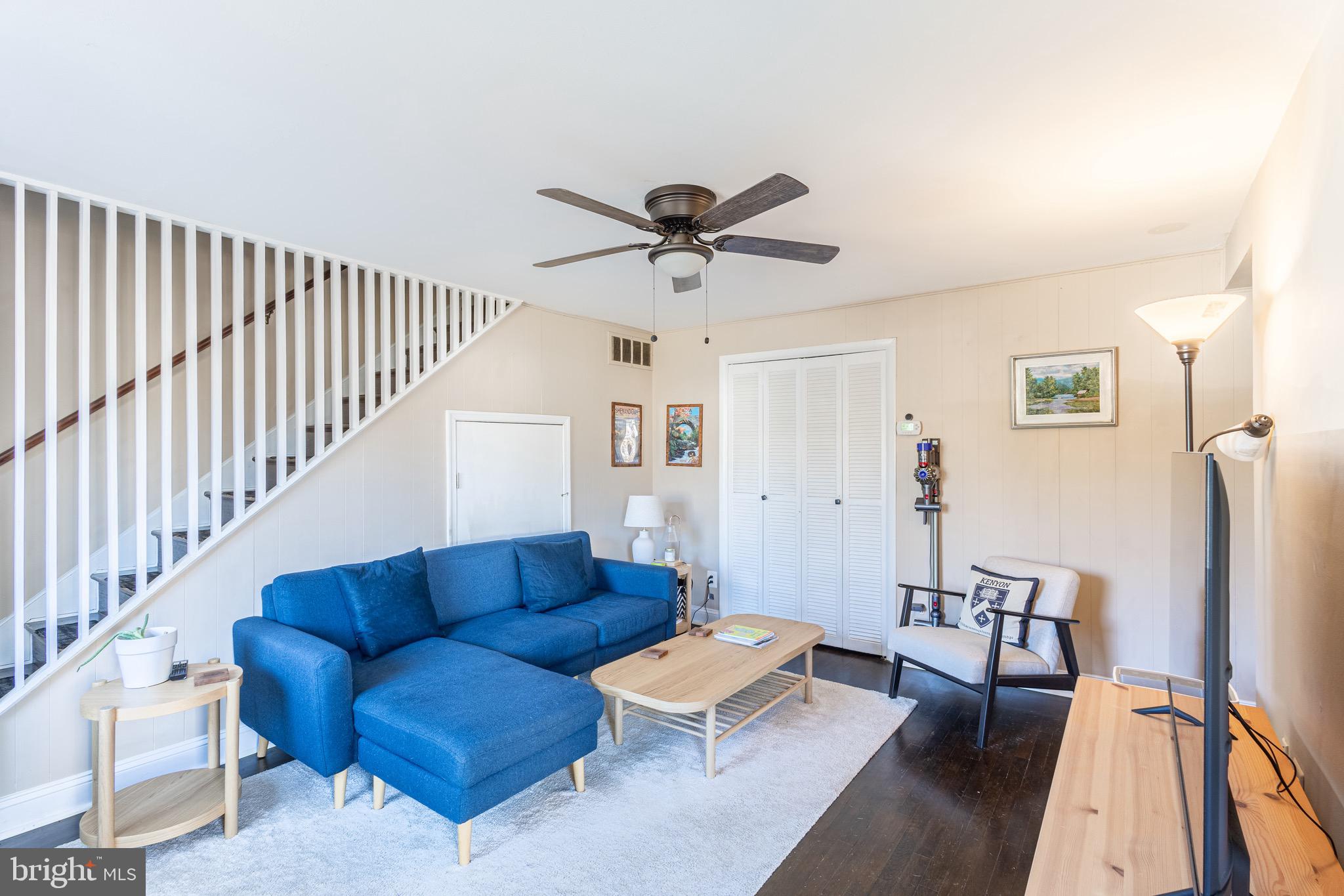 10611 Maple Street Fairfax, VA 22030 - Photo 2 of 20 a living room with furniture ceiling fan and a rug