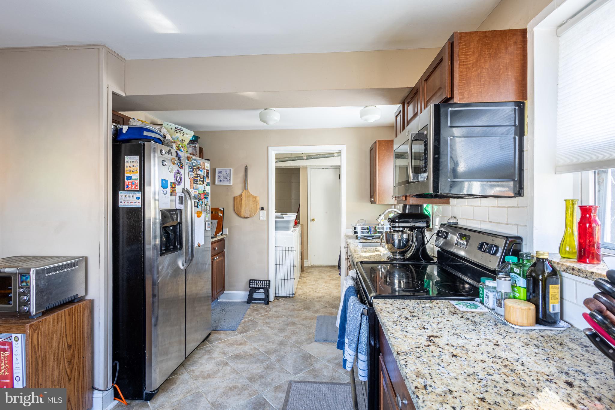 10611 Maple Street Fairfax, VA 22030 - Photo 6 of 20 a kitchen with stainless steel appliances granite countertop a refrigerator and a sink