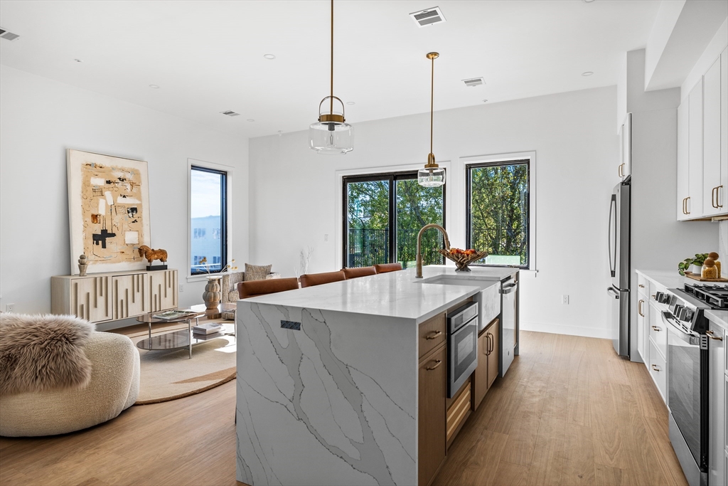 125 Addison Street, Unit 206 Boston, MA 02128 - Photo 9 of 17 a kitchen with counter top space and stainless steel appliances