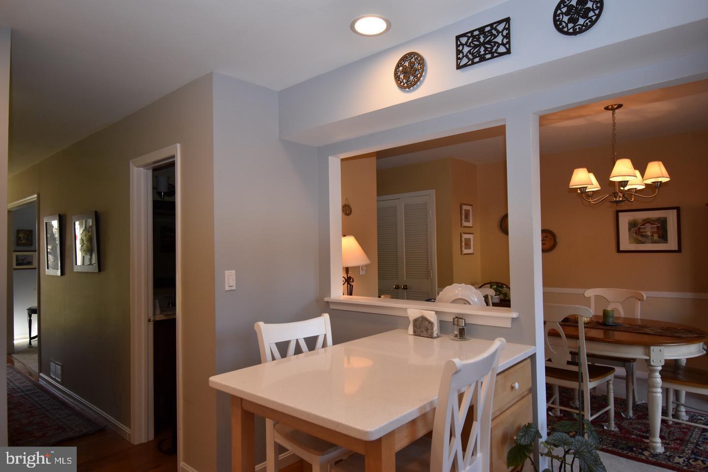 8244 Carrleigh Parkway Springfield, VA 22152 - Photo 12 of 25 a view of a dining room with furniture and wooden floor