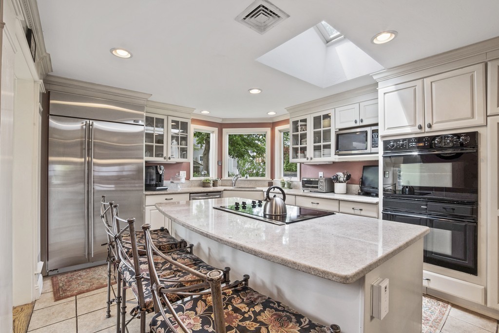 26 Howe Street Hingham, MA 02043 - Photo 11 of 30 a kitchen with stainless steel appliances granite countertop a sink and a refrigerator