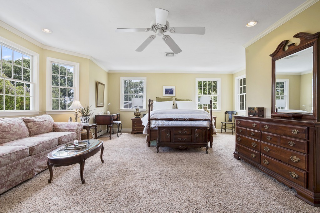 26 Howe Street Hingham, MA 02043 - Photo 16 of 30 a bedroom with a bed a couch and large windows