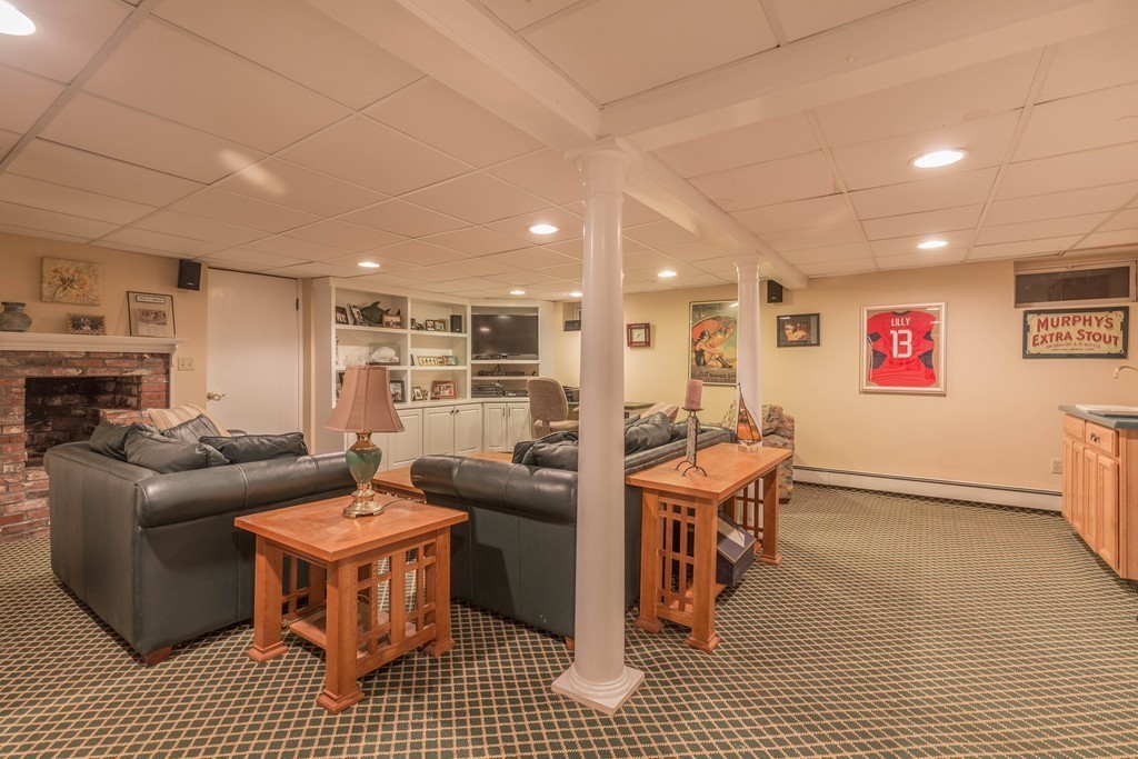26 Howe Street Hingham, MA 02043 - Photo 27 of 30 a living room with furniture and a fireplace