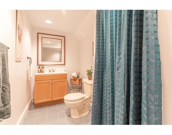 26 Howe Street Hingham, MA 02043 - Photo 28 of 30 a bathroom with a toilet a sink and a mirror