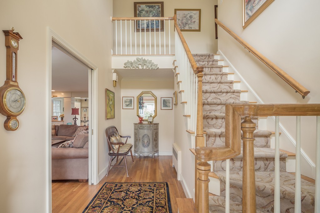 26 Howe Street Hingham, MA 02043 - Photo 6 of 30 a view of a hallway with wooden floor and dining room