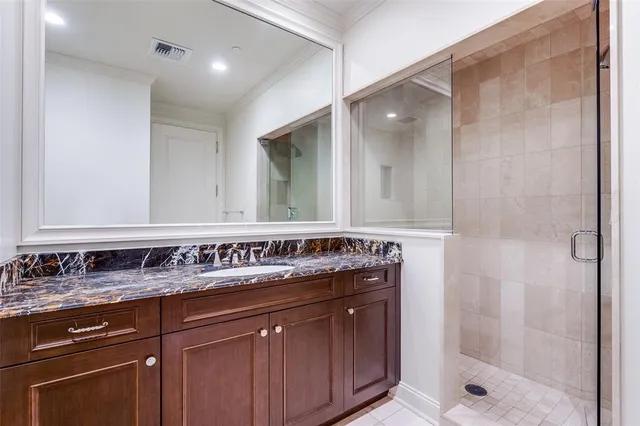 a bathroom with a shower sink and mirror