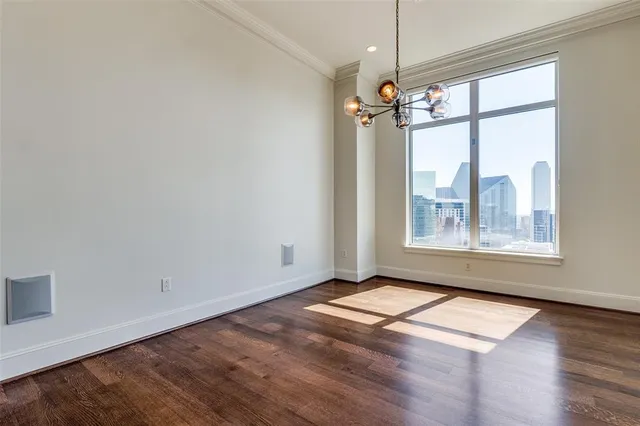 a view of a room with wooden floor and a window