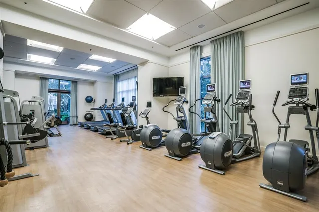a view of a park with couches and table and chairs under an umbrella