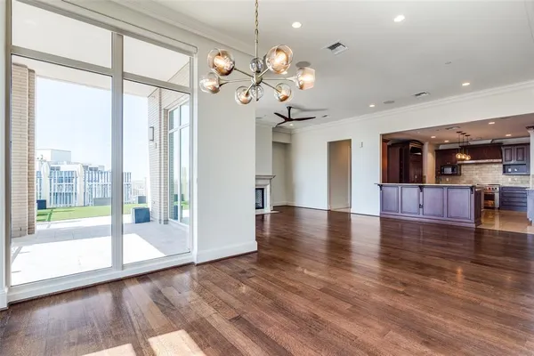 a view of a big room with wooden floor and windows