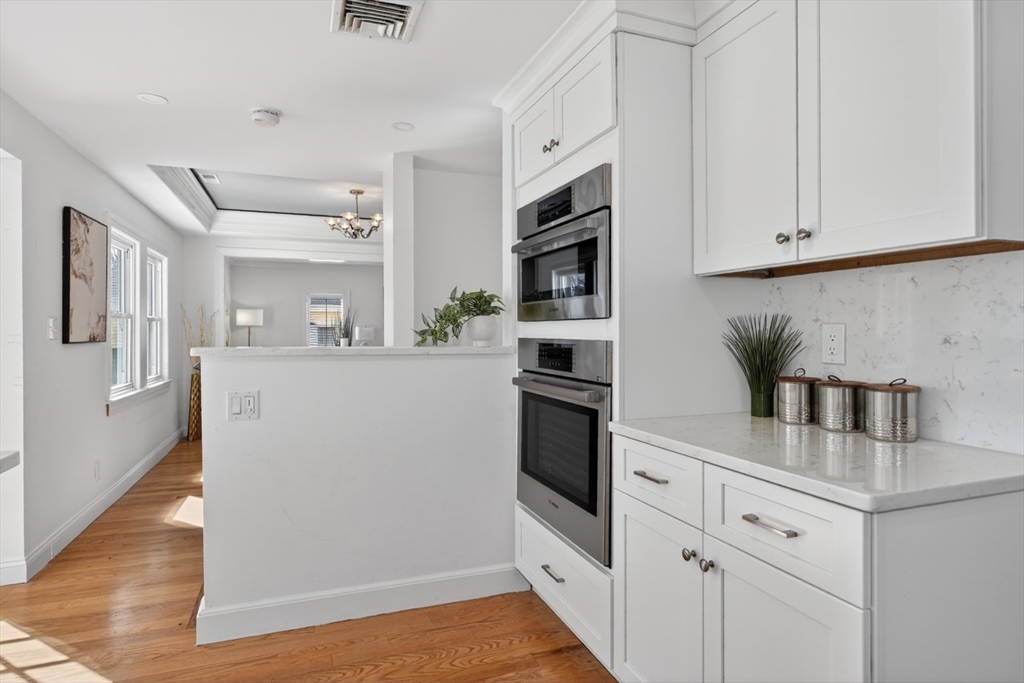 23 Stearns Road Belmont, MA 02478 - Photo 12 of 42 a kitchen with stainless steel appliances a sink a refrigerator a counter space and cabinets