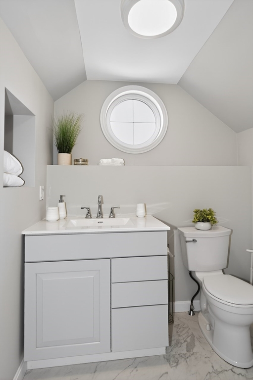 23 Stearns Road Belmont, MA 02478 - Photo 34 of 42 a bathroom with a toilet a sink a mirror and window