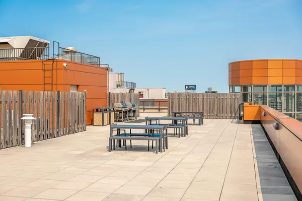 a view of a roof deck with furniture
