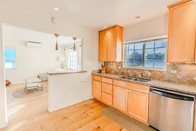 a large white kitchen with a sink and cabinets