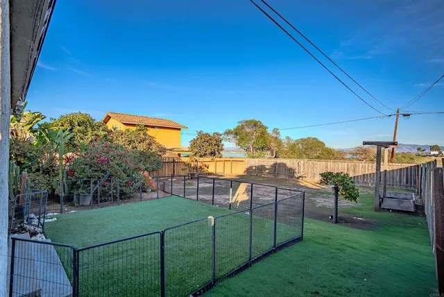 a view of a house with backyard and sitting area