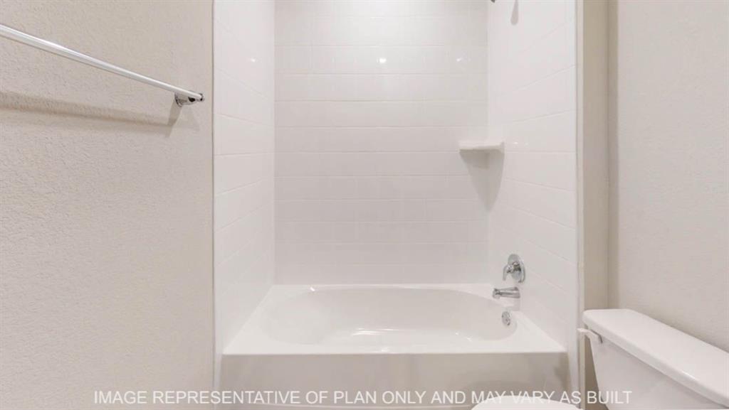 10409 Altair Drive Waco, TX 76708 - Photo 11 of 11 White tiled shower and tub combination featuring a chrome faucet