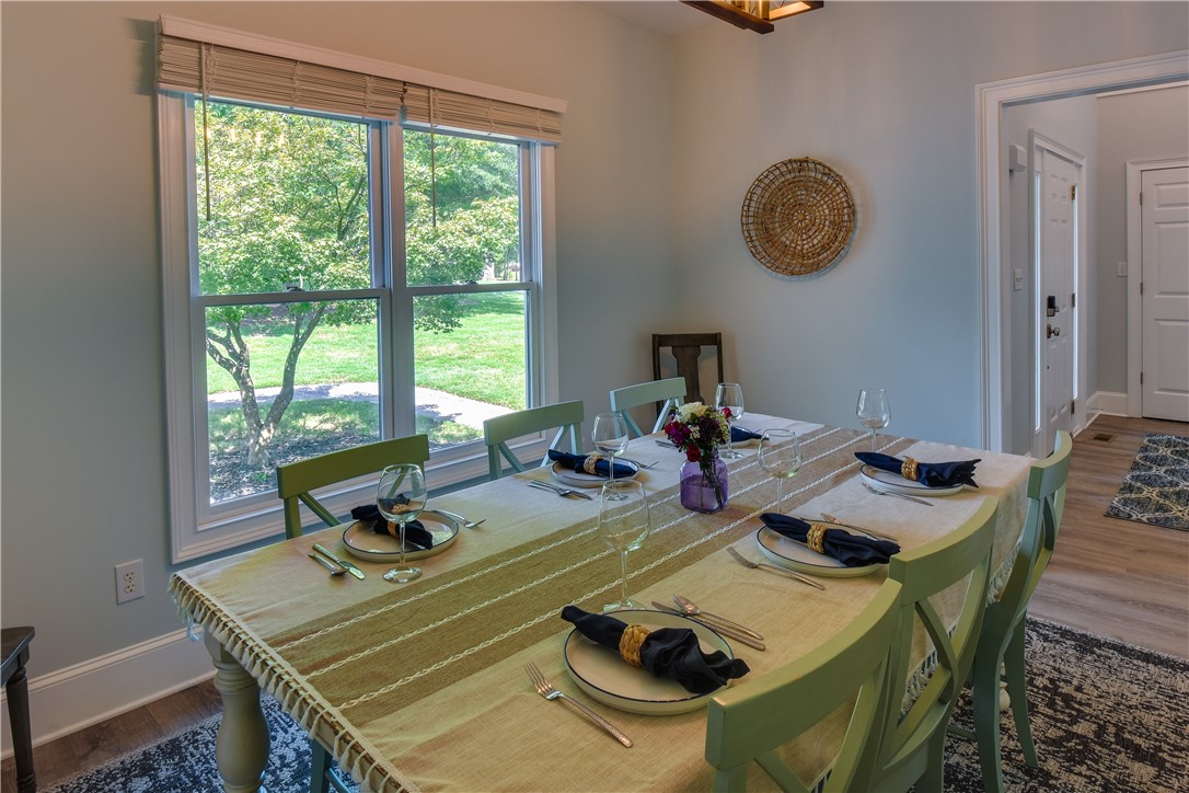 206 Petty Road Seneca, SC 29672 - Photo 14 of 48 Natural light floods this inviting dining space with a picturesque view of lush greenery.