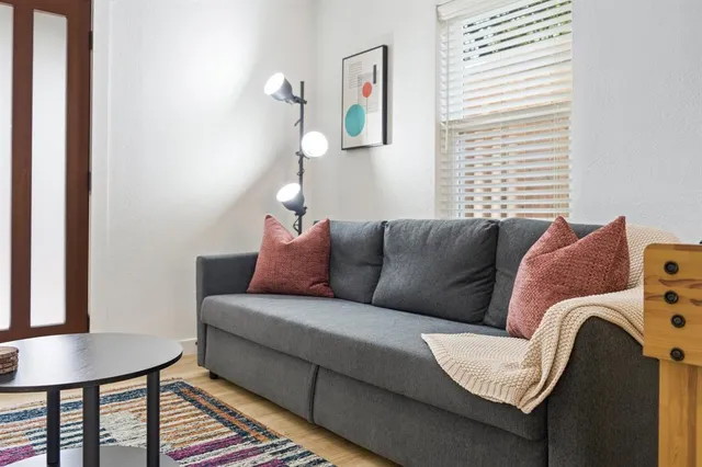 a living room with a couch and a window