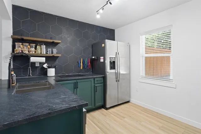 a kitchen with a sink cabinets and window