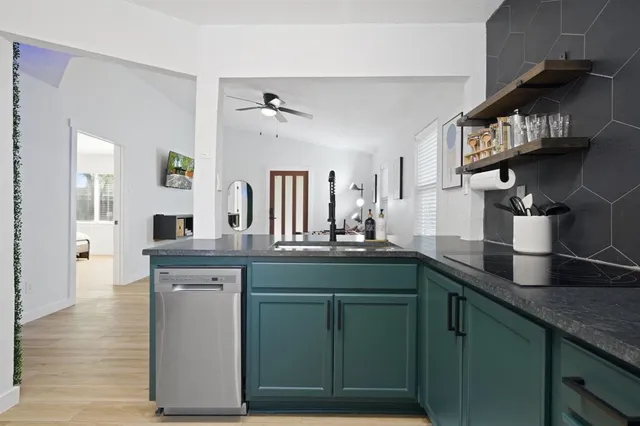 a kitchen with stainless steel appliances granite countertop a sink and cabinets