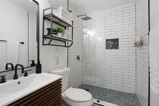 a bathroom with a toilet sink and mirror