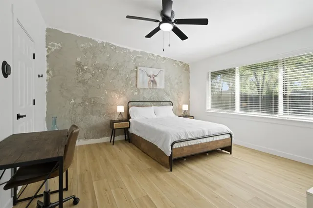 a bedroom with a bed and a table