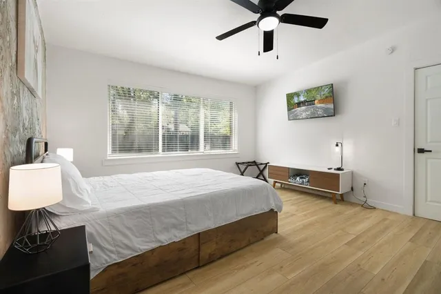 a bedroom with a bed and a desk