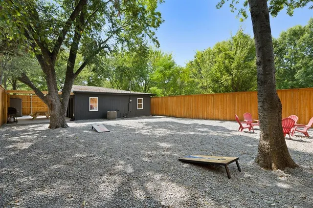 a backyard of a house with yard and tree