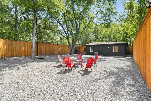 a view of a house with backyard and sitting area