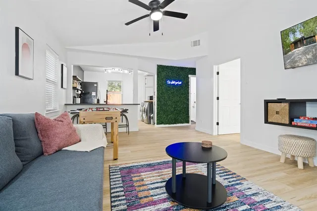 a living room with furniture and a wooden floor