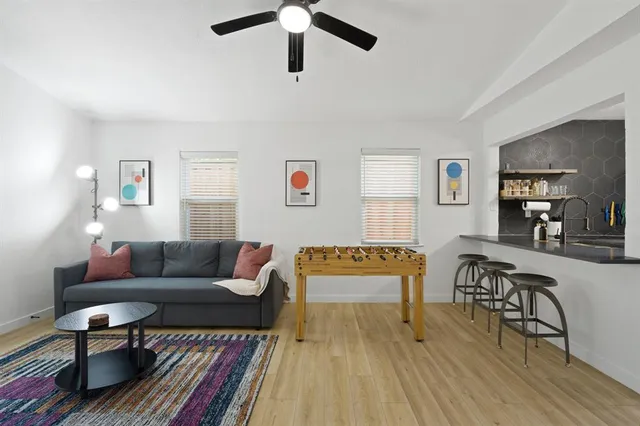 a living room with furniture and a wooden floor