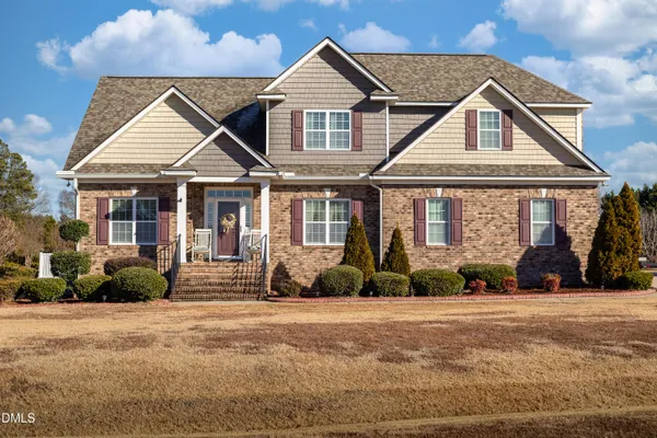 a front view of a house with a yard
