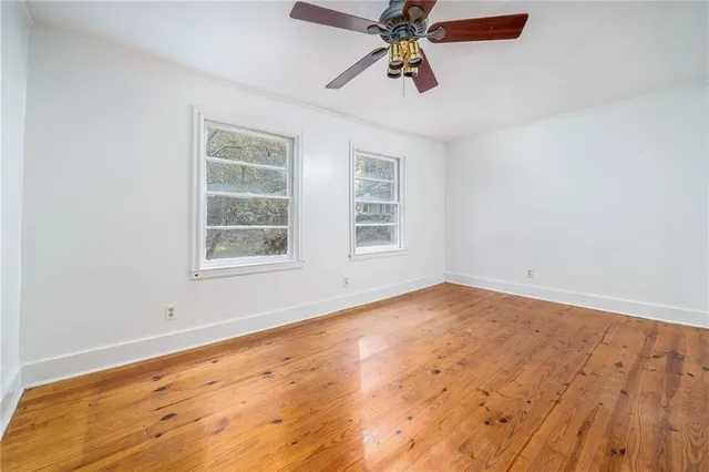 a view of an empty room with closet and a window