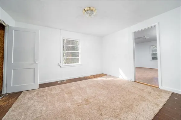 an empty room with a empty space and windows