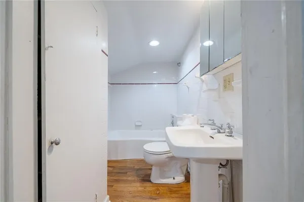 a view of an empty room with a window and fireplace