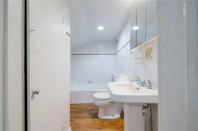 a view of an empty room with a window and fireplace