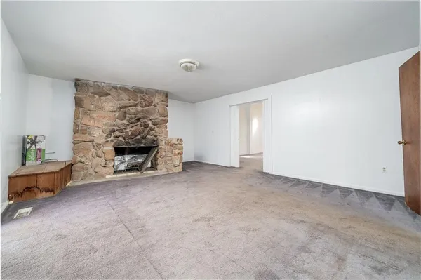 an empty room with a closet and cabinet