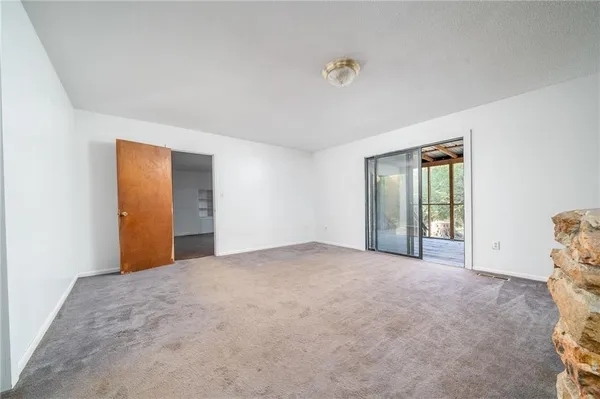 a view of an empty room with a large window