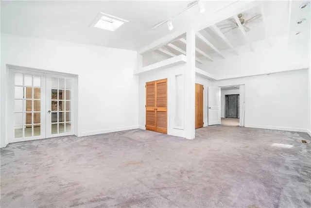 a kitchen with stainless steel appliances granite countertop a refrigerator a stove and a sink with wooden cabinets