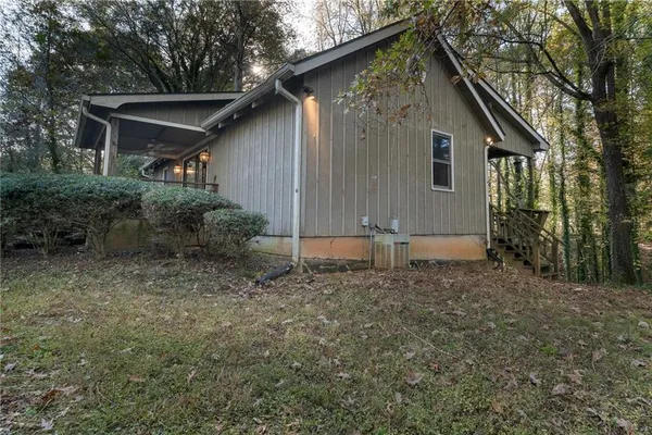 a backyard of a house with table and chairs